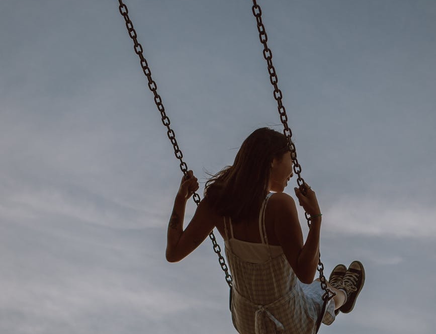 woman swinging on swing and enjoying ride