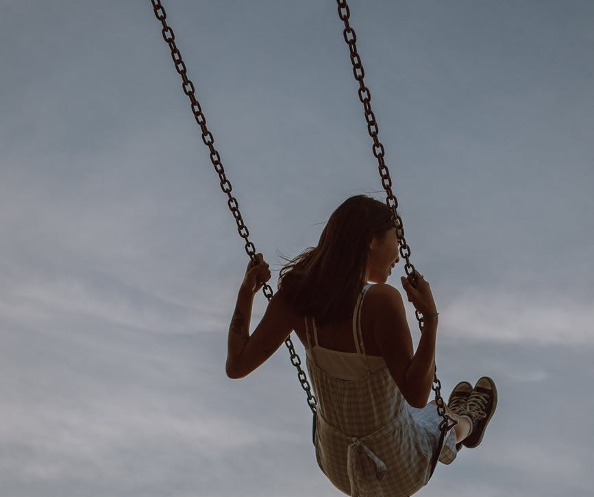 woman swinging on swing and enjoying ride
