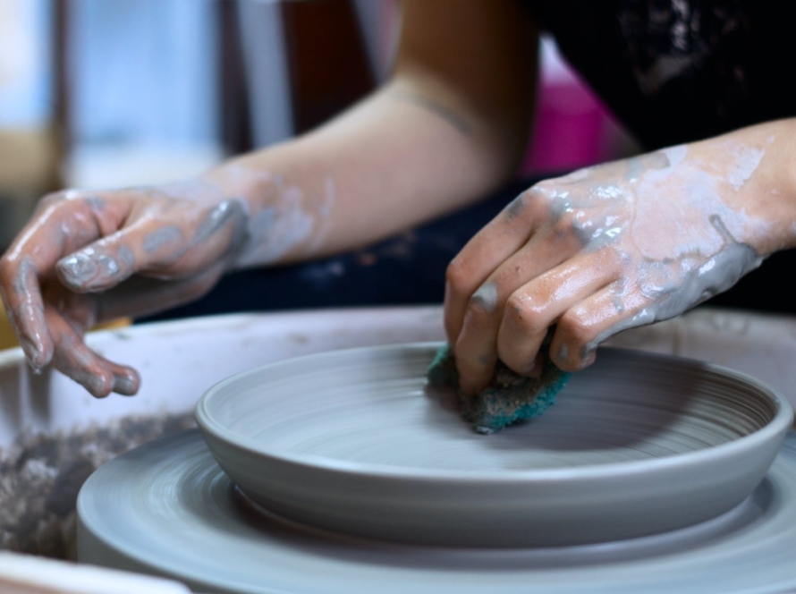 person making clay pot