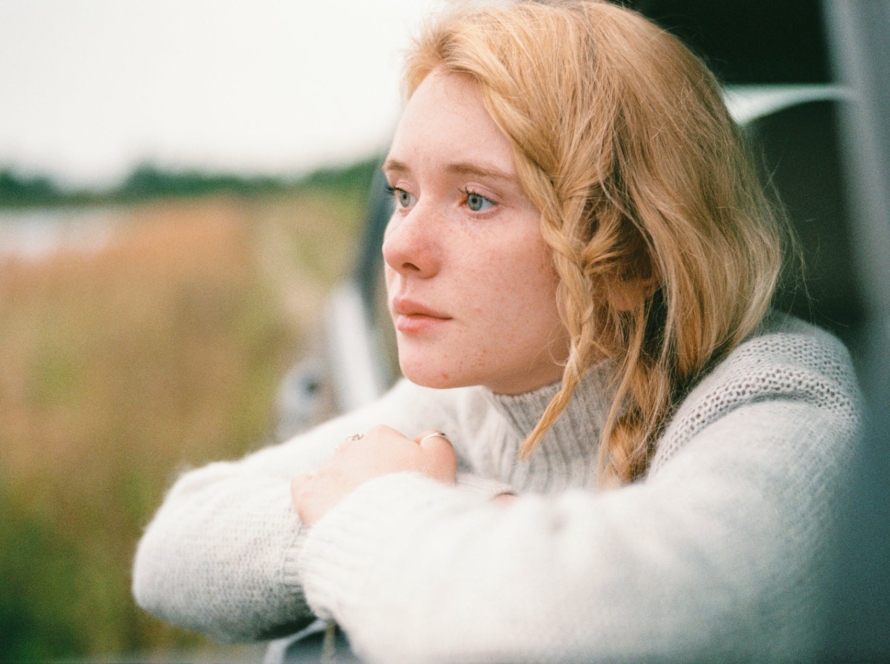 woman in white sweater thinking