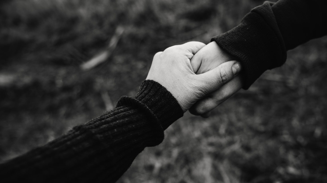 black and white photo of holding hands