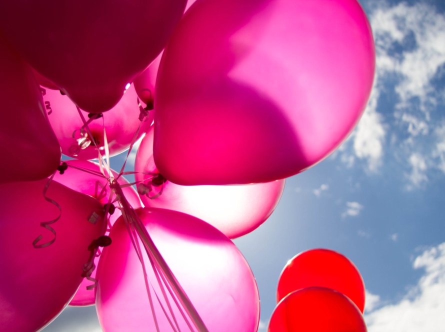 pink and red balloons during daytime
