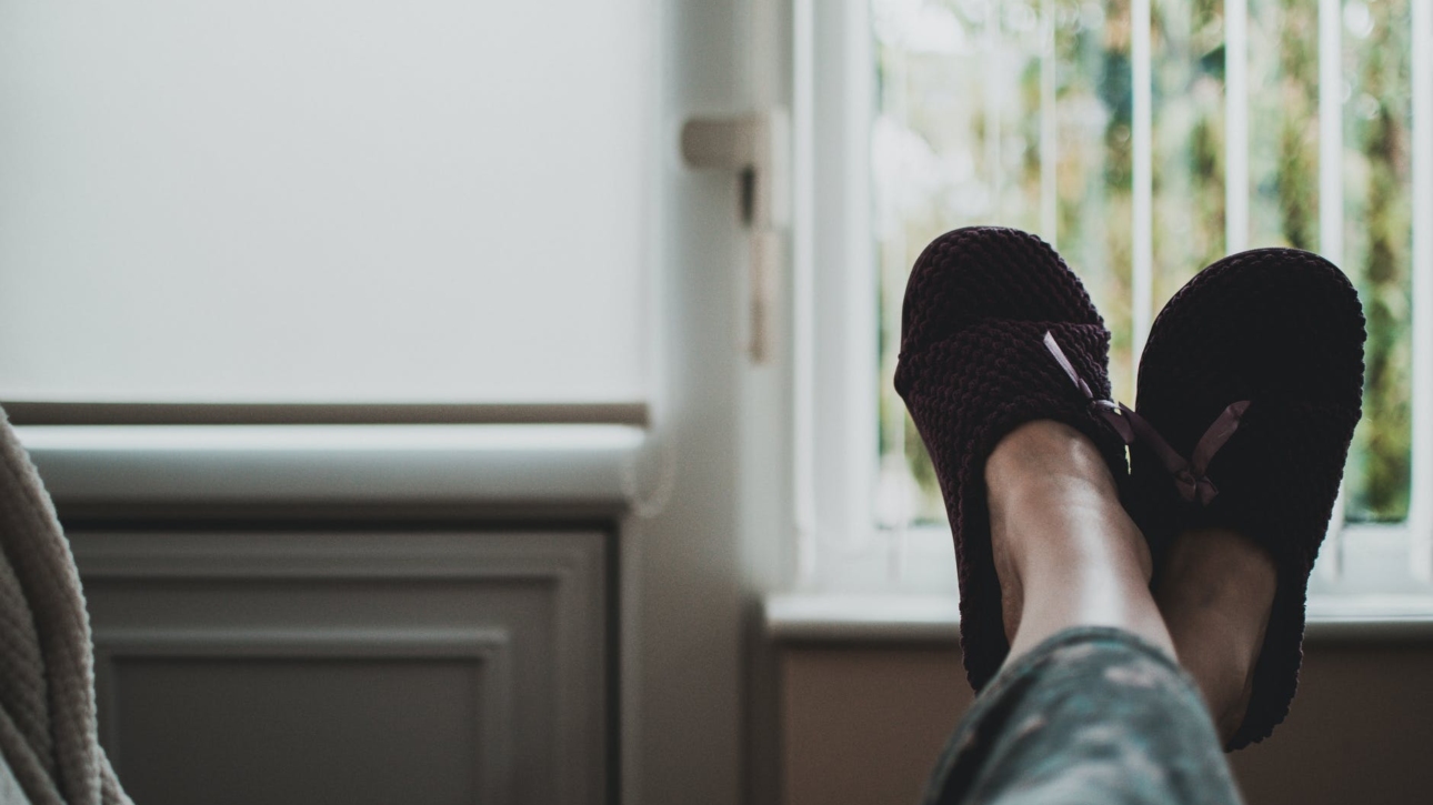 person wearing pair of black slides