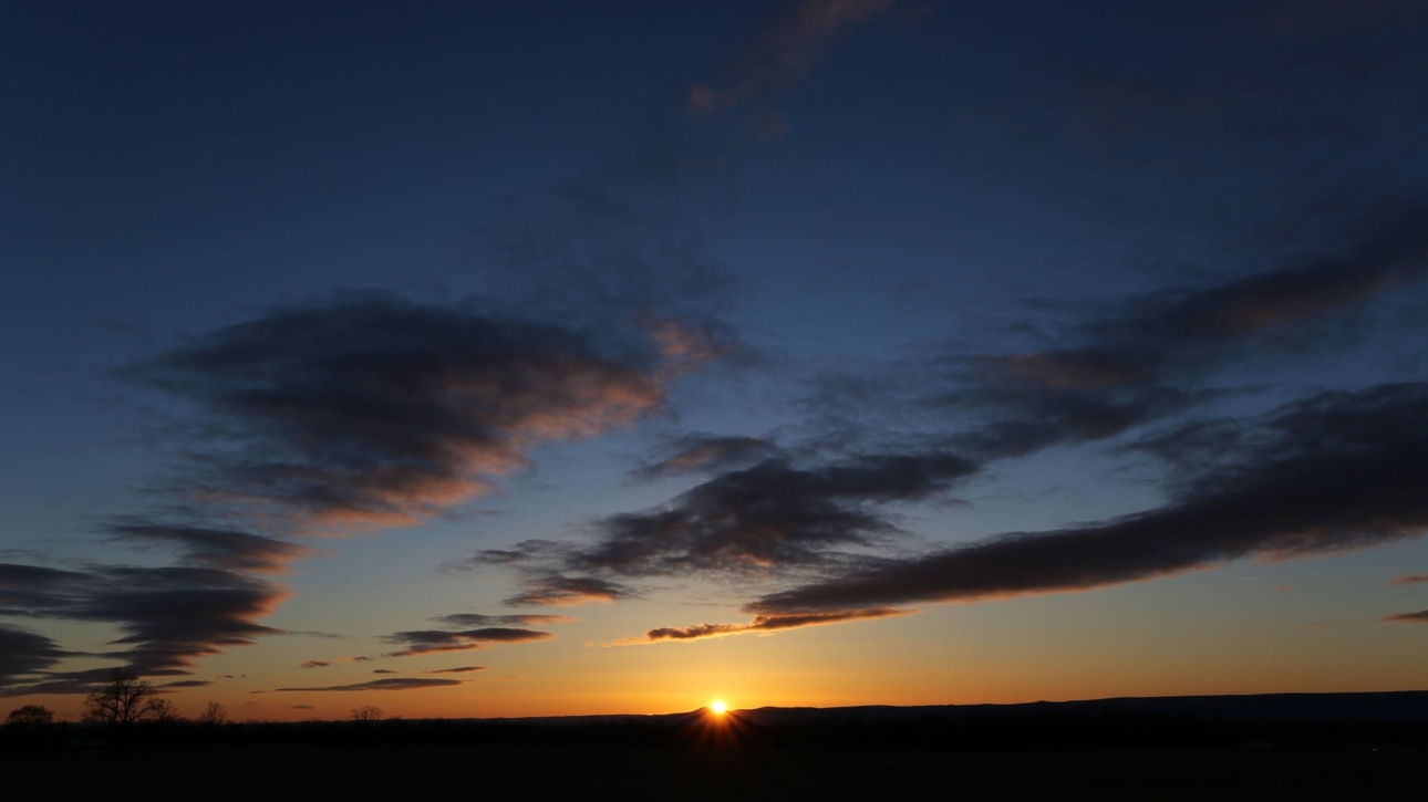 backlit beach clouds dawn