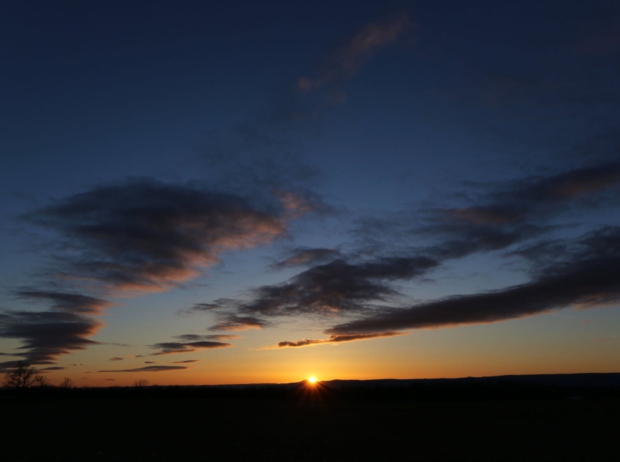 backlit beach clouds dawn