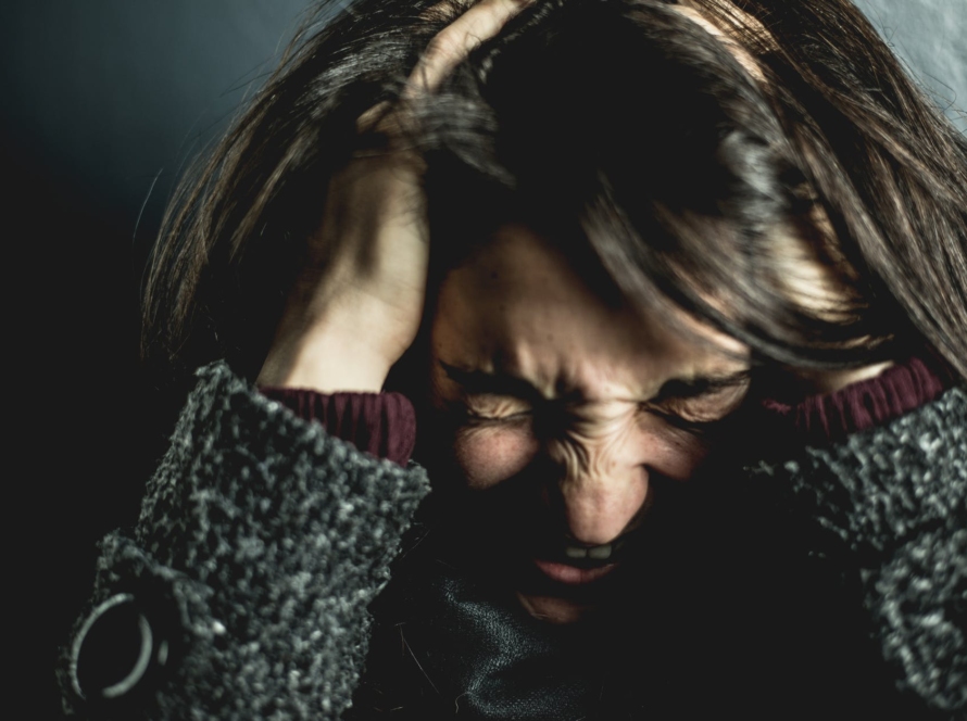 woman holding her head