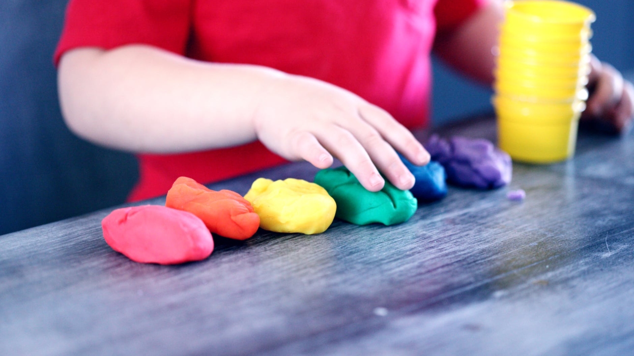 person making clay figures
